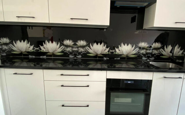 Panel szklany w kuchni - lilia na czarny tle biała kuchnia Leszno